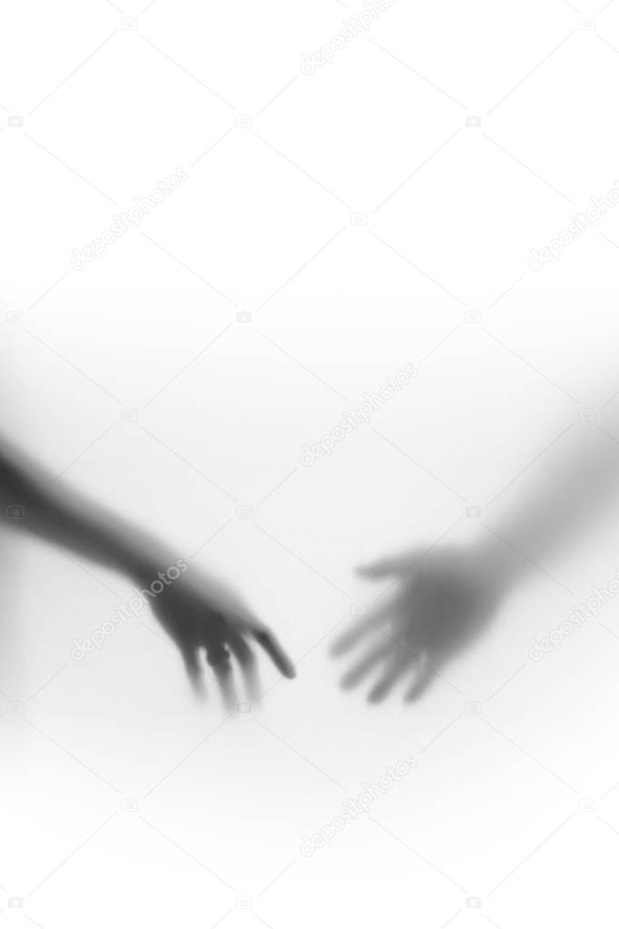 Male and female hands silhouette, almost touch each-other