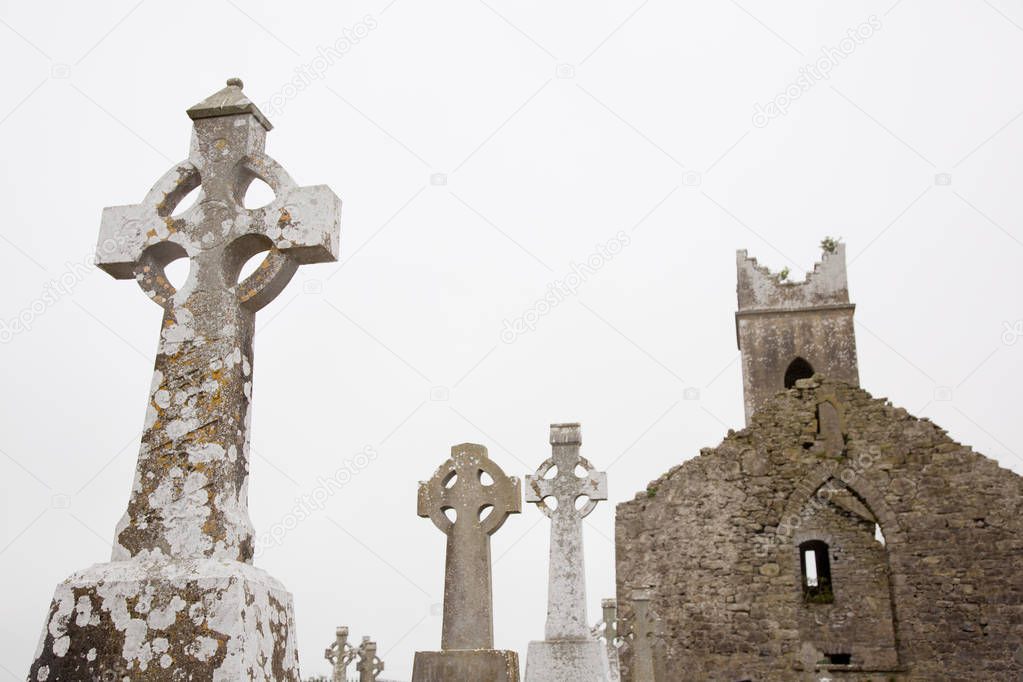 Irish christian graveyard, tomb stones with old church ruin