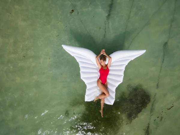 Beautiful Sexy Attractive Woman Red Swimsuit Lays Wing Shaped Inflatable — Stock Photo, Image