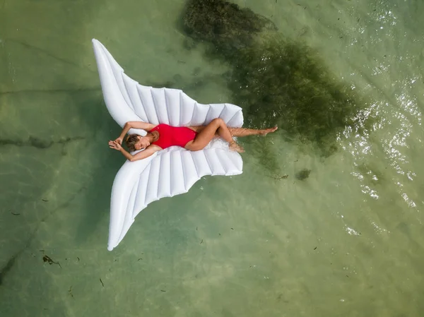 Beautiful Sexy Attractive Woman Red Swimsuit Lays Wing Shaped Inflatable — Stock Photo, Image