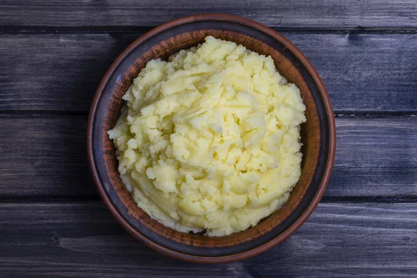 Mashed potatoes in a plate on the wooden table — Stock Photo, Image