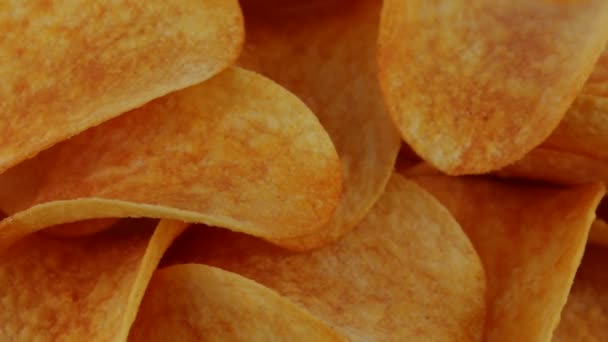 Rotating potato chips closeup, macro view food background — Stock Video