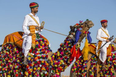 Geleneksel Rajasthani elbise giyen deve ve Hint erkek Jaisalmer, Rajasthan, Hindistan çöl Festivali olarak Bay Desert yarışmaya katılmak