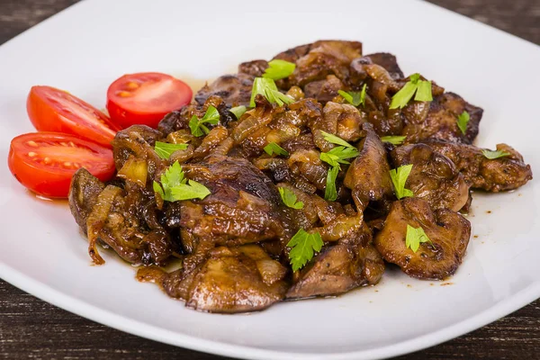 Chicken livers in a creamy sauce with onion on white plate — Stock Photo, Image