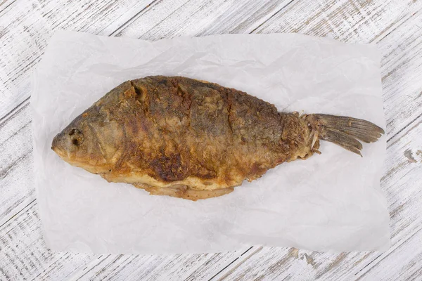 Fried fish crucian on wooden table background — Stock Image Fried fish crucian on wooden table background Royalty Free Stock Images