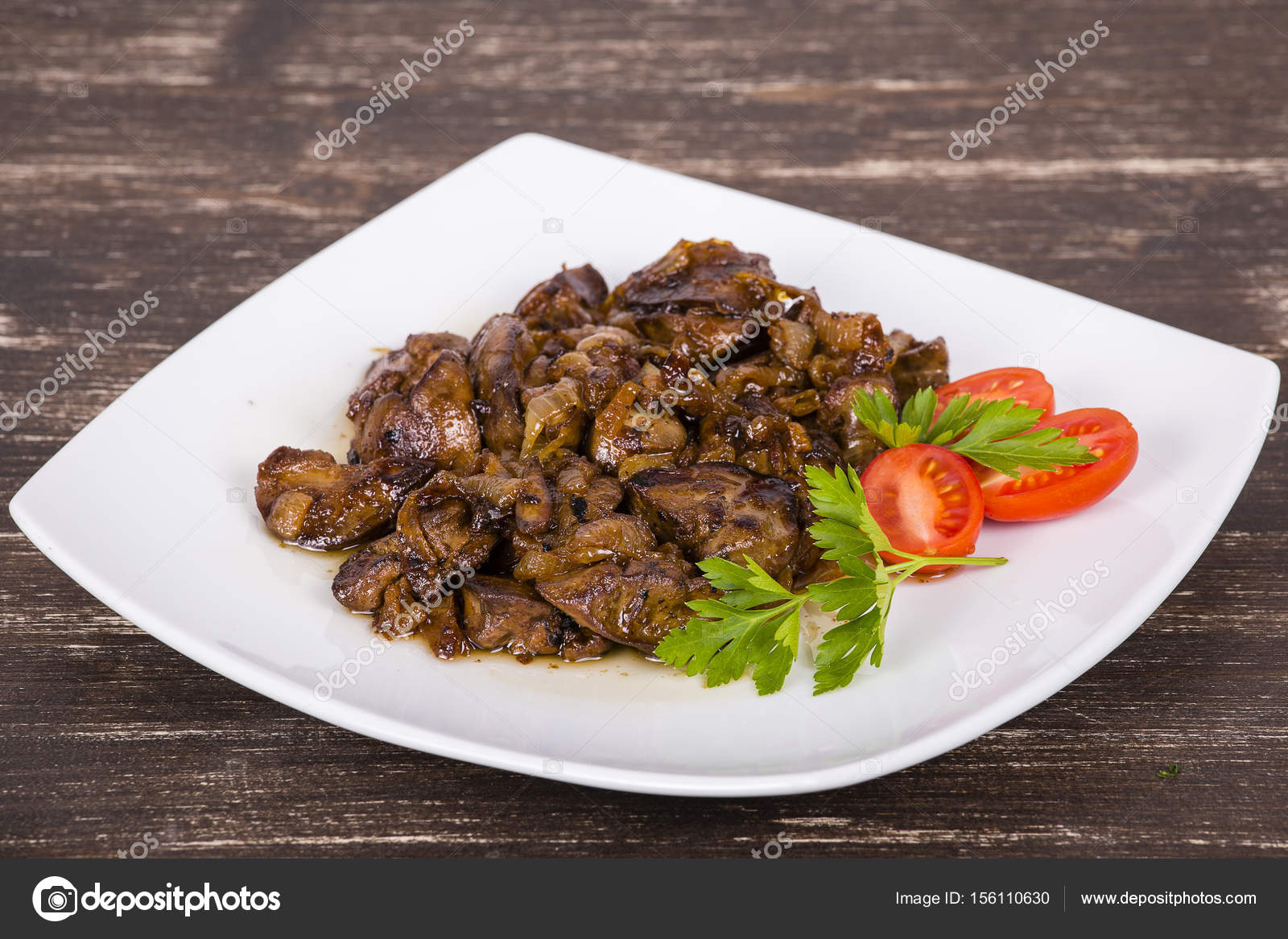 Chicken livers in a creamy sauce with onion on white plate Stock Photo