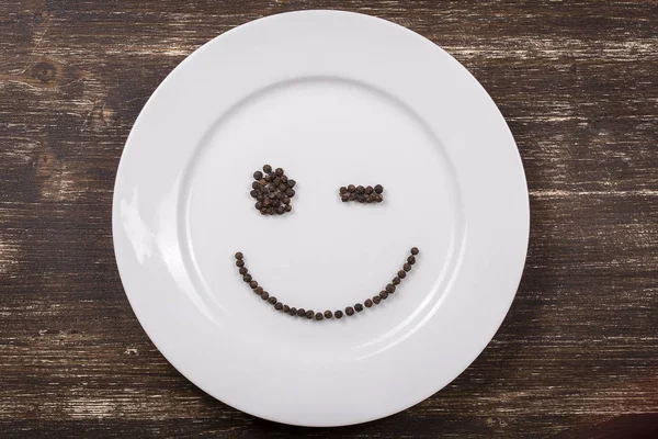 Happy smiley face on dish white plate — Stock Photo, Image