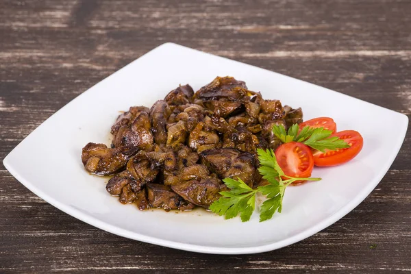 Chicken livers in a creamy sauce with onion on white plate — Stock Photo, Image