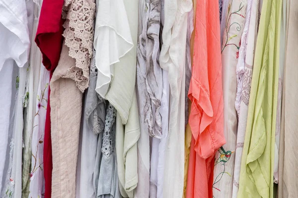 Series of female summer dresses hanging on a hanger on the market for sale — Stock Photo, Image