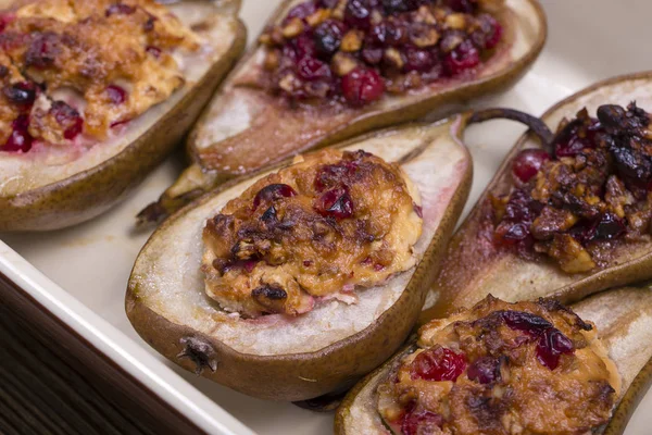 Homemade baked pears with cottage cheese, honey, red cranberries and walnuts, close up — Stock Photo, Image
