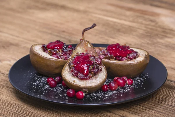 Homemade baked pears with honey, red cranberries and walnuts, close up — Stock Photo, Image