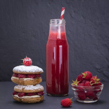 Ahududu, peynir, yulaf kurabiye tatlım ve siyah arduvaz kaplamak, yakın çekim ham Ahududu ve kırmızı suyu arka plan üzerine