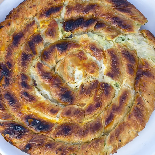 Round burek or pie in white plate, close up. Turkey — Stock Photo, Image