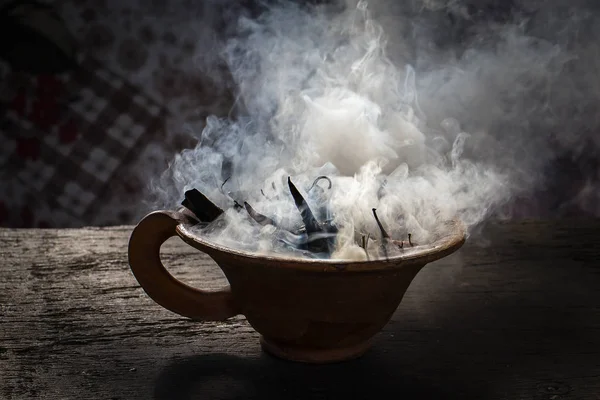 Steaming clay cup with spices on wooden table. Still-life on a background. Nepal. Close up — Stock Photo, Image