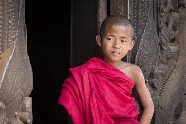 Młody mnich siedząc i patrząc w klasztorze Shwenandaw. Mandalay, Birma, — Zdjęcie stockowe