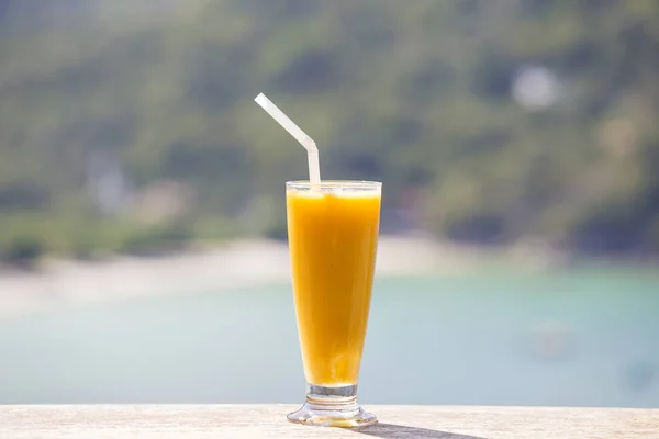 Fresh organic Mango shake in thai restaurant on the beach near sea , Thailand. Close up — Stock Photo, Image