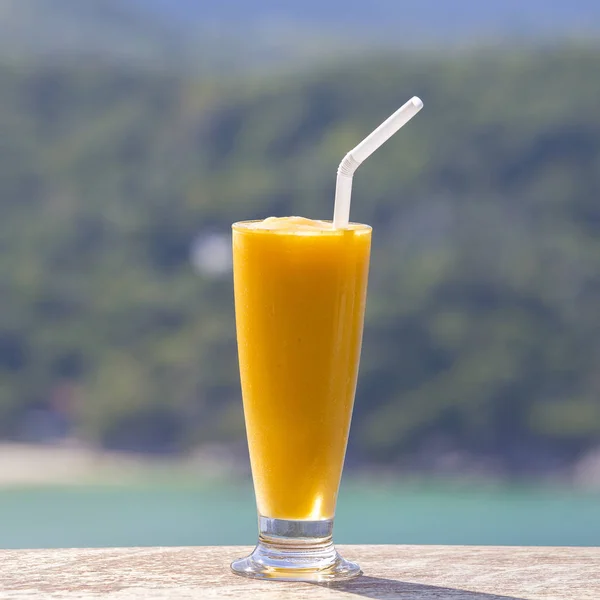 Fresh organic Mango shake in thai restaurant on the beach near sea , Thailand. Close up — Stock Photo, Image