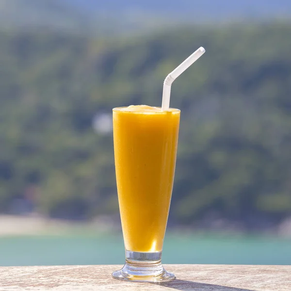 Manga orgânica fresca agitar no restaurante tailandês na praia perto do mar, Tailândia. Fechar — Fotografia de Stock