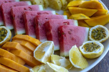 Tropical fruits on a breakfast plate, close up