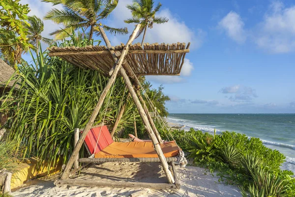 Drewniana huśtawka pod baldachimem na tropikalnej plaży w pobliżu morza, wyspa Zanzibar, Tanzania, Afryka Wschodnia — Zdjęcie stockowe