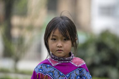 Sapa, Vietnam - march 02, 2020 : Ethnic Hmong young girl on the street in Sapa region, North Vietnam