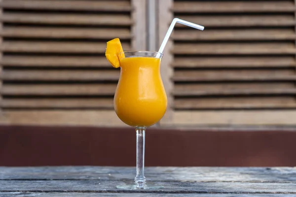 Freshly squeezed juice from mango in a glass goblet. Island of Zanzibar, Tanzania, East Africa. Close up