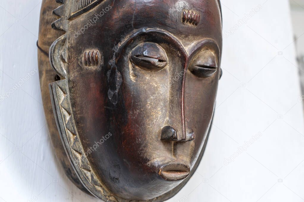 African mask on a stone wall background, Tanzania, east Africa. Close up