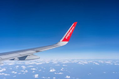 Kota Kinabalu, Malezya - 29 Şubat 2020: VietJet Air şirketinin ve bulutlu gökyüzünün kanadı, Kota Kinabalu adası, Borneo adası, Malezya yakınlarındaki pencereden uçaktan görüş.