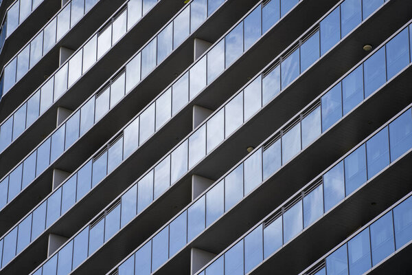 High glass skyscrapers on the streets of Singapore. Office windows background, close up