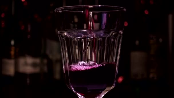 Vino tinto se vierte en una copa — Vídeo de stock