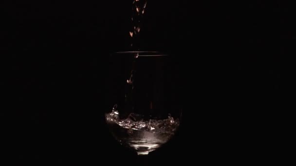 Slow mo bursts of rose wine in the glass — Stock Video