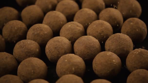 Slow mo. Chocolate candy, truffle, sprinkle with cocoa powder — Stock Video