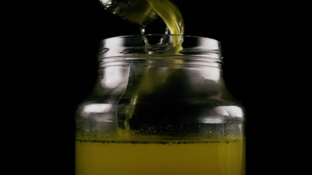 Slow mo. A large stream and a drop of broth in a jar — Stock Video