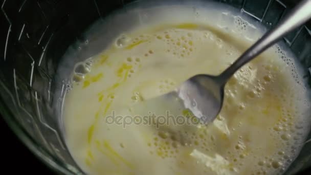 Tenedor en un tazón de huevos y mezclar la leche. Movimiento lento — Vídeo de stock