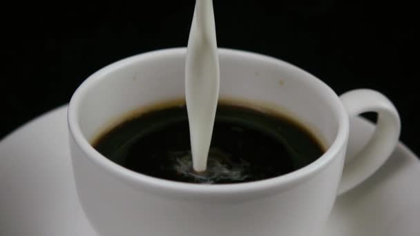 Café negro en una taza y vierta la leche. Lento mo — Vídeo de stock