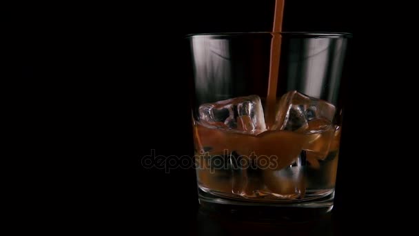 Vodka with ice in a glass on a table. Slow mo — Stock Video