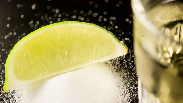 A slice of lime on salt in focus — Stock Photo, Image