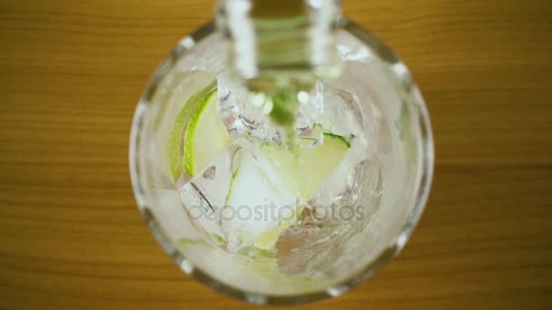 Gerakan lambat. Green drink pour into a glass with ice top view — Stok Video