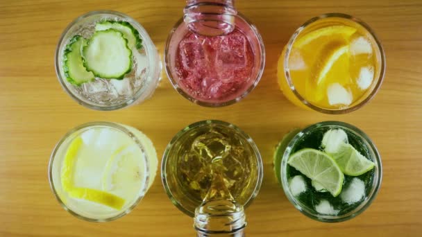 Slow mo. Six different drinks in two glasses to pour a drink top view — Stock Video