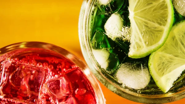 Lime with ice in a glass and red drink top view — Stock Photo, Image