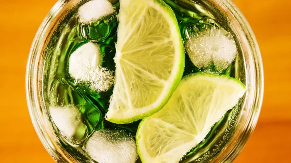 Ice and lime in a glass of water top view — Stock Photo, Image