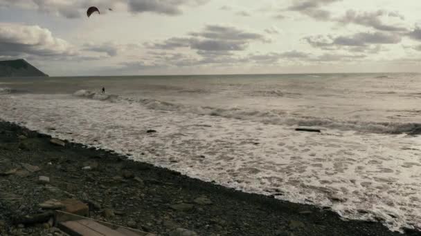 Виндсерфер в море под хмурым небом — стоковое видео