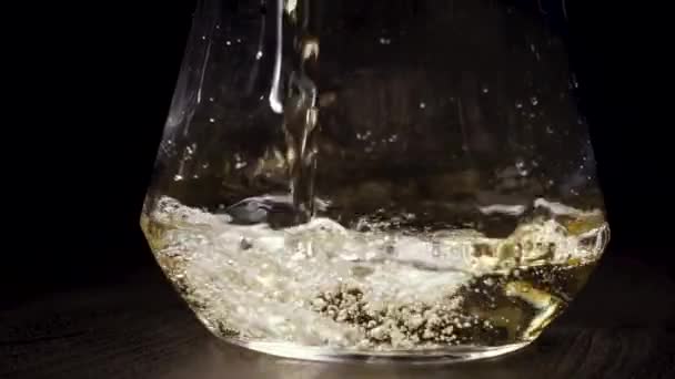 Le vin blanc est versé dans la carafe 