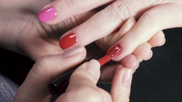 Cover the little finger with red lacquer gel — Stock Video