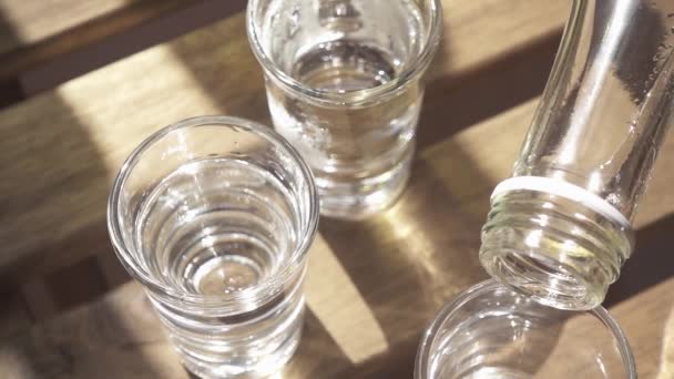 Vodka öntenek a szemüveg egyik a táblázat lassú mozgás — Stock videók