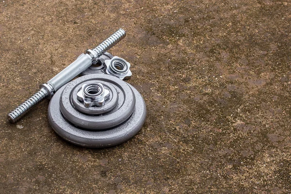 Close up dumbbells on cement floor — Stock Photo, Image