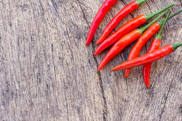 Red chili on an old wooden background. — Stock Photo, Image