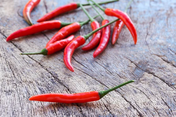 Fresh red chili on an old wooden background. — Stock Photo, Image