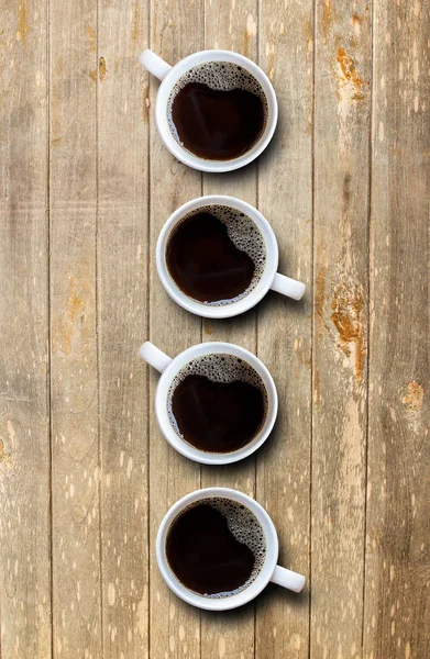 Xícara de café na mesa de madeira vista superior — Fotografia de Stock