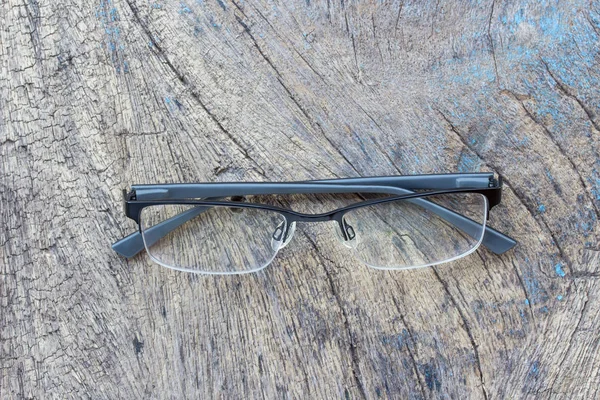 गडद लाकडी टेबलवर चष्मा पडतात . — स्टॉक फोटो, इमेज
